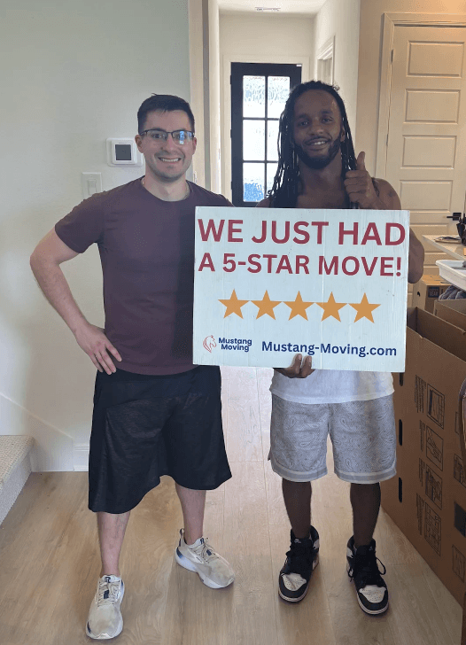 Mustang Moving customer Mike R. with a long-tenured crew member inside his new home.