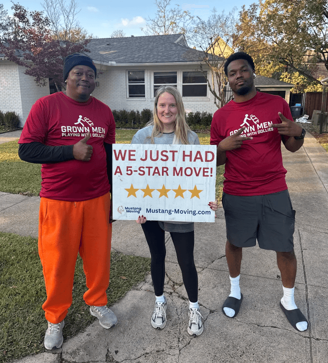 Mustang Moving customer Mason F. with two crew members in front of his home in winter.