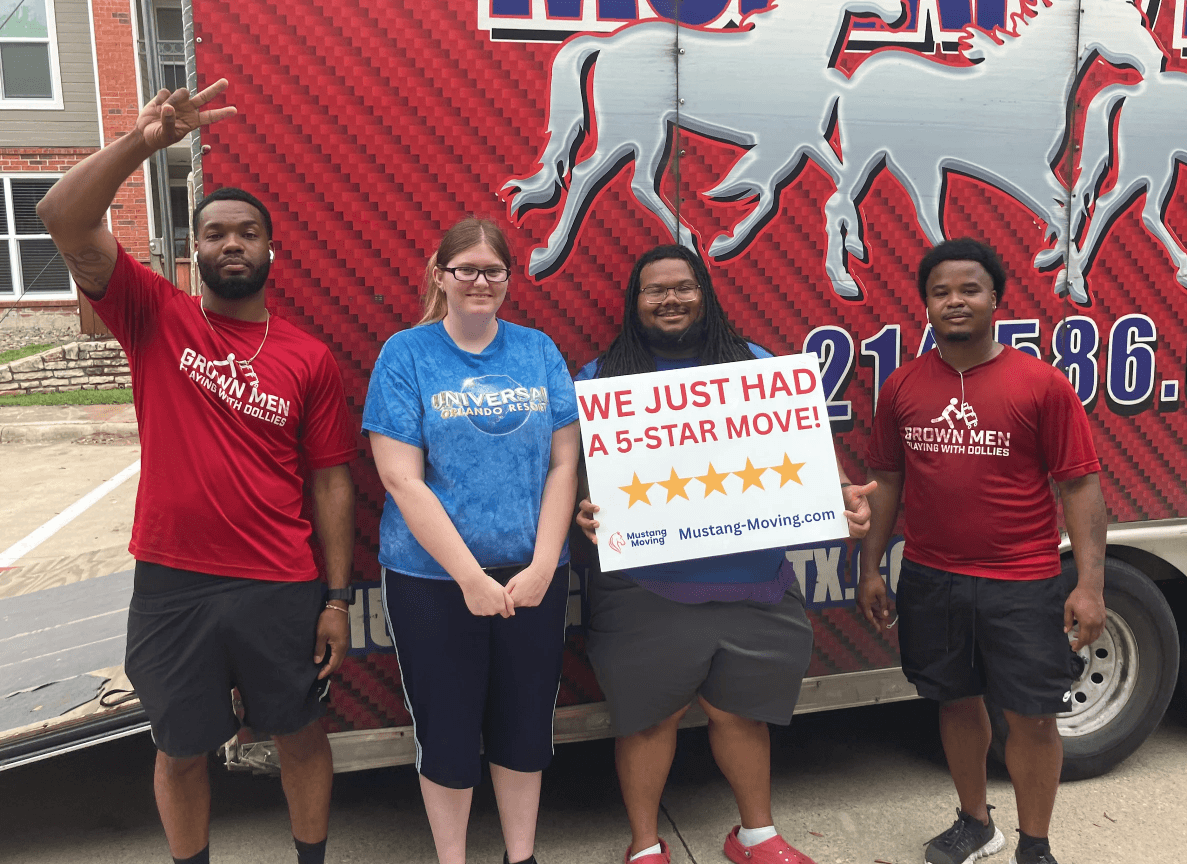 Mustang Moving customer Hannah B. with three crew members in front of a Mustang Moving truck at her new apartment.