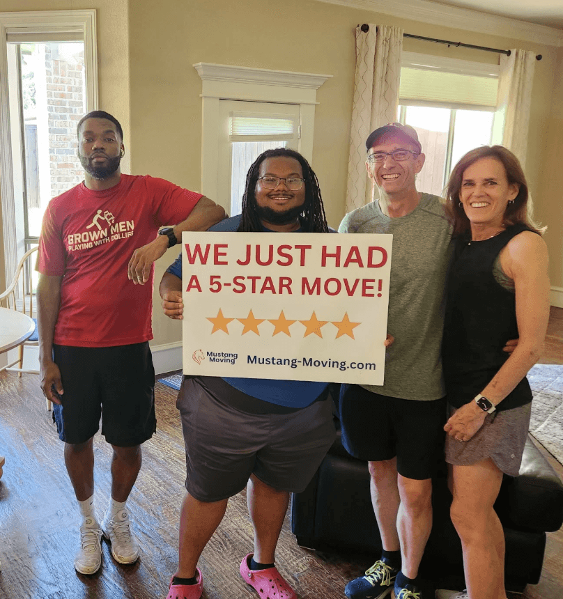 Mustang Moving customers the Coleman family with two crew members inside their living room.
