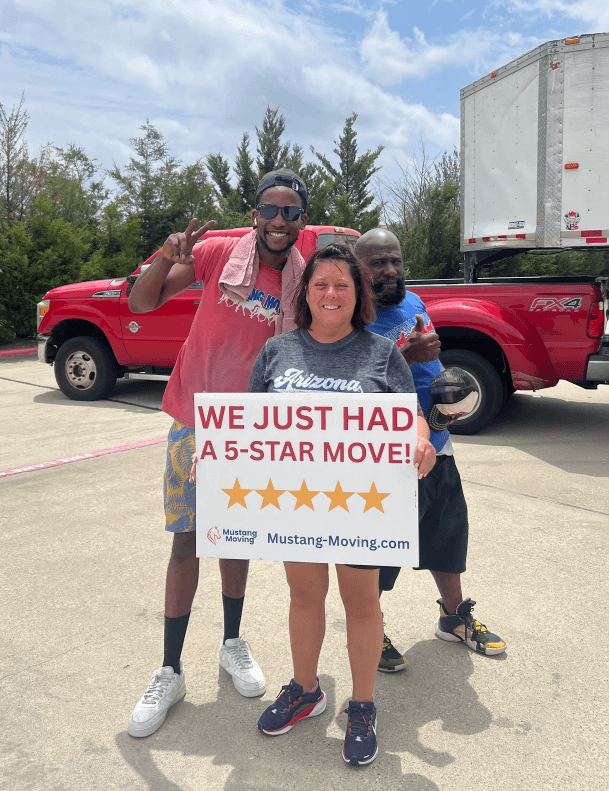 Mustang Moving customer Danielle K. with two crew members in front of her moving truck.