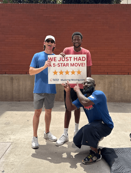 Mustang Moving customer Ben S. with two crew members on a sidewalk.