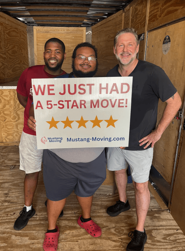 Mustang Moving customer Greg P. with two crew members inside the moving trailer.