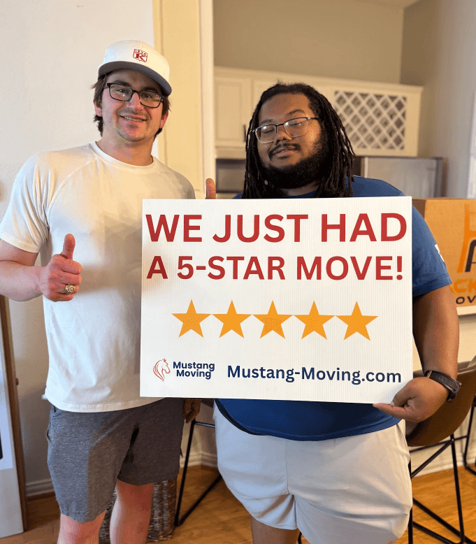 Mustang Moving customer Tyler G. with a crew member inside his new kitchen.