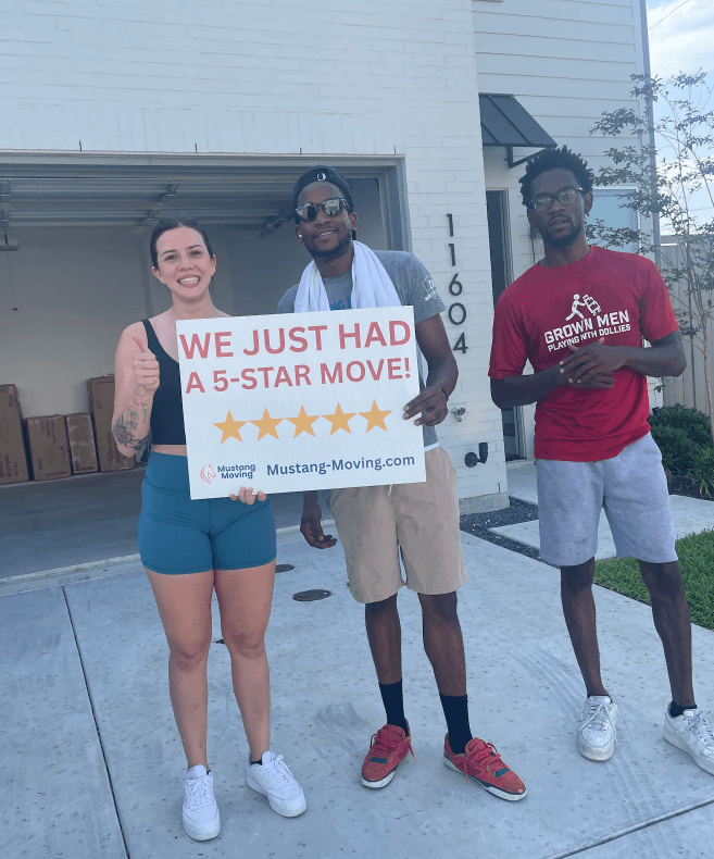 Mustang Moving customer Brittany H. with two crew members in front of her new home.
