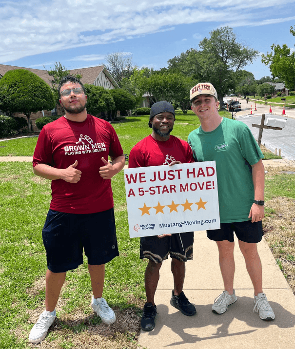 Mustang Moving customers the Patel family with three crew members in their front yard.